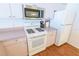 Modern kitchen appliances including microwave, oven, and refrigerator, providing functionality and style at 8201 Se 169Th Palownia Loop, The Villages, FL 32162