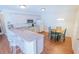 Bright kitchen with a breakfast bar, white cabinets, and a cozy dining area for casual meals at 8201 Se 169Th Palownia Loop, The Villages, FL 32162