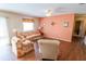 The bright living room has neutral furniture and great natural light creating a warm and inviting space at 8201 Se 169Th Palownia Loop, The Villages, FL 32162