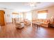 Inviting living room features wood flooring, comfortable seating, and a ceiling fan for added comfort at 8201 Se 169Th Palownia Loop, The Villages, FL 32162