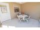 The screened porch features a cozy table with chairs perfect for enjoying the fresh air and relaxed living at 8201 Se 169Th Palownia Loop, The Villages, FL 32162