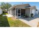 The cozy screened porch features a table and chairs and is great for enjoying the outdoors at 8201 Se 169Th Palownia Loop, The Villages, FL 32162
