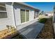 Paved back patio perfect for outdoor entertaining with sliding glass door access to the home at 8233 Se 169Th Palownia Loop, The Villages, FL 32162