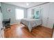 Serene bedroom boasts built-in storage cabinets, wood floors, and a bright, airy ambiance at 8233 Se 169Th Palownia Loop, The Villages, FL 32162