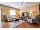 Cozy living room showcasing hardwood floors, a ceiling fan, and comfortable seating arrangement at 8233 Se 169Th Palownia Loop, The Villages, FL 32162