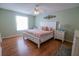 Comfortable main bedroom offering a spacious layout, wood floors, and natural light at 8233 Se 169Th Palownia Loop, The Villages, FL 32162
