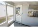 Cozy screened-in porch with tiled floor and access to the home's interior and backyard at 8233 Se 169Th Palownia Loop, The Villages, FL 32162