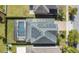 Aerial view of a private pool with screened enclosure, solar panels, and well-maintained lawn in backyard at 8549 Lovett Ave, Orlando, FL 32832