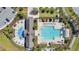 Aerial view of community pool, splash pad, and lounge area surrounded by lush landscaping and ample seating at 8549 Lovett Ave, Orlando, FL 32832
