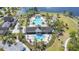Overhead shot showcases community pool and splash pad, with palm trees, lake, and amenity center at 8549 Lovett Ave, Orlando, FL 32832
