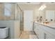Modern bathroom with a glass-enclosed shower and dual sink vanity at 8549 Lovett Ave, Orlando, FL 32832