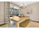 Cozy dining area with views of the outdoor pool, stylish light fixture, and seamless indoor-outdoor living at 8549 Lovett Ave, Orlando, FL 32832