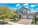 Charming two-story home with a paved driveway, lush landscaping, and a two-car garage at 8549 Lovett Ave, Orlando, FL 32832