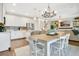 Bright kitchen and dining area with white cabinets, stainless steel appliances, and seamless living area transition at 8549 Lovett Ave, Orlando, FL 32832