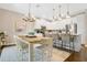 Bright kitchen and dining area featuring white cabinets, stainless steel appliances, and a cozy dining space at 8549 Lovett Ave, Orlando, FL 32832