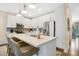 Bright, white kitchen with stainless steel appliances and a large island with seating at 8549 Lovett Ave, Orlando, FL 32832