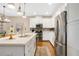 Modern kitchen with white cabinetry, stainless steel appliances, and hardwood floors at 8549 Lovett Ave, Orlando, FL 32832