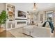 Cozy living room featuring a fireplace, built-in shelves, comfortable seating, and a large television at 8549 Lovett Ave, Orlando, FL 32832