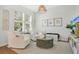 Cozy living room with neutral tones, stylish decor, hardwood flooring, and natural light from large windows at 8549 Lovett Ave, Orlando, FL 32832