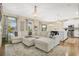 Open-concept living room with hardwood floors, comfortable seating, elegant lighting, and seamless transition to the kitchen at 8549 Lovett Ave, Orlando, FL 32832