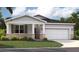Charming single-story home featuring a stone-accented facade, well-manicured lawn, and an attached two-car garage at 917 Pearlwood Loop, Eagle Lake, FL 33839