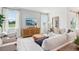Bright and airy living room featuring a large sofa, two armchairs, a large screen TV, and beautiful views at 917 Pearlwood Loop, Eagle Lake, FL 33839