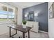 Well-lit home office features a desk, globe, lamps, and storage cabinet, creating a productive workspace at 917 Pearlwood Loop, Eagle Lake, FL 33839