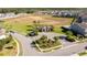 An aerial of the community clubhouse, showcasing amenities and proximity to green areas within the neighborhood at 9513 Amber Chestnut Way, Winter Garden, FL 34787