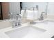 Bathroom showcasing double sinks with chrome fixtures, quartz countertop and decorative towels at 9513 Amber Chestnut Way, Winter Garden, FL 34787