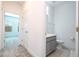 Bathroom access and toilet area featuring gray vanity with sleek hardware and neutral flooring at 9513 Amber Chestnut Way, Winter Garden, FL 34787