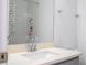 Close up of bathroom vanity, featuring white countertop, chrome faucet, and shower with colorful curtain at 9513 Amber Chestnut Way, Winter Garden, FL 34787