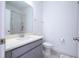 Bright bathroom featuring gray vanity, white quartz countertop and combination shower and bathtub at 9513 Amber Chestnut Way, Winter Garden, FL 34787
