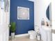 Elegant powder room with blue walls, modern fixtures, and stylish decor at 9513 Amber Chestnut Way, Winter Garden, FL 34787