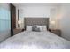 Bright bedroom featuring a large window, tufted headboard, bedside tables and lamps at 9513 Amber Chestnut Way, Winter Garden, FL 34787