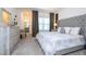 Bright bedroom featuring a large window, dresser, bedside tables, lamps, and ensuite bath at 9513 Amber Chestnut Way, Winter Garden, FL 34787