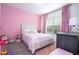 Pink bedroom featuring a bed, window, curtains, nightstand, and carpet at 9513 Amber Chestnut Way, Winter Garden, FL 34787