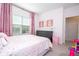 Charming bedroom with gray dresser, pink curtains and accents creating a cozy and inviting space at 9513 Amber Chestnut Way, Winter Garden, FL 34787