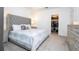 Bright bedroom featuring a large window, dresser, bedside tables, lamps and walk-in closet at 9513 Amber Chestnut Way, Winter Garden, FL 34787