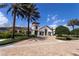 Elegant clubhouse entrance with lush landscaping and a stately tower, offering a grand welcome at 9513 Amber Chestnut Way, Winter Garden, FL 34787