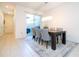 Bright dining room with a modern chandelier, seating for six, and sliding glass doors to the patio at 9513 Amber Chestnut Way, Winter Garden, FL 34787