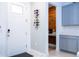 Inviting entryway with a wine rack, white door and a glimpse into a wood-paneled coffee bar at 9513 Amber Chestnut Way, Winter Garden, FL 34787