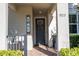 A welcoming front entrance featuring a stylish door, decorative wreath, and charming 'HOME' sign at 9513 Amber Chestnut Way, Winter Garden, FL 34787