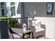 Cozy front porch features comfortable seating, a small table, and a decorative lantern for relaxing outdoors at 9513 Amber Chestnut Way, Winter Garden, FL 34787