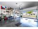 View of the epoxy floor, storage shelves, and open garage door showing the houses across the street at 9513 Amber Chestnut Way, Winter Garden, FL 34787