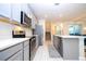 Modern kitchen featuring sleek appliances, white countertops, and a central island at 9513 Amber Chestnut Way, Winter Garden, FL 34787