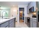 Modern kitchen with gray cabinets, stainless steel appliances, and quartz countertops at 9513 Amber Chestnut Way, Winter Garden, FL 34787