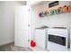 Bright laundry room featuring a modern washer and dryer with plenty of storage space at 9513 Amber Chestnut Way, Winter Garden, FL 34787
