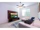 Comfortable living room with a ceiling fan, flat screen television, and a plush white sectional couch at 9513 Amber Chestnut Way, Winter Garden, FL 34787