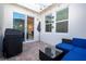 Inviting patio with an outdoor grill, and a comfortable seating area with a glass table at 9513 Amber Chestnut Way, Winter Garden, FL 34787