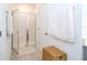 A bright white tiled shower with a glass door is featured in the bathroom at 9513 Amber Chestnut Way, Winter Garden, FL 34787